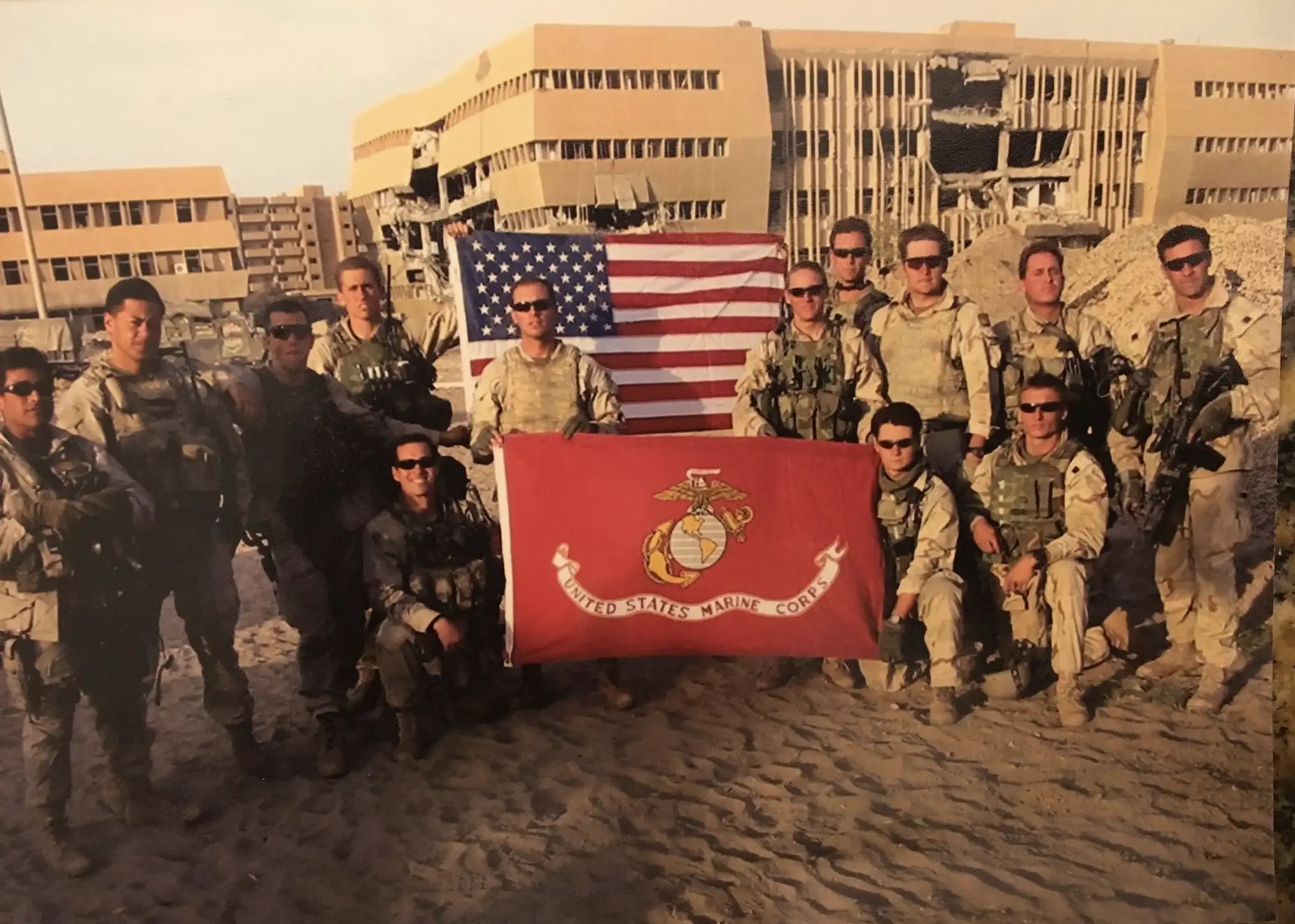 Soldiers holding American and Marine Corps flags.
