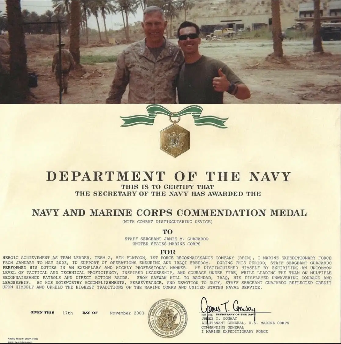 Military commendation certificate with two people.