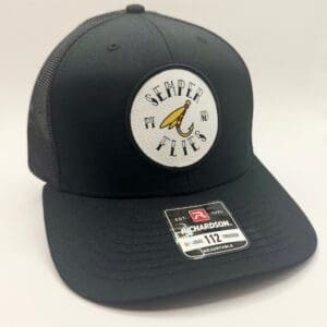 Black mesh trucker hat with a circular logo featuring a banana and text.