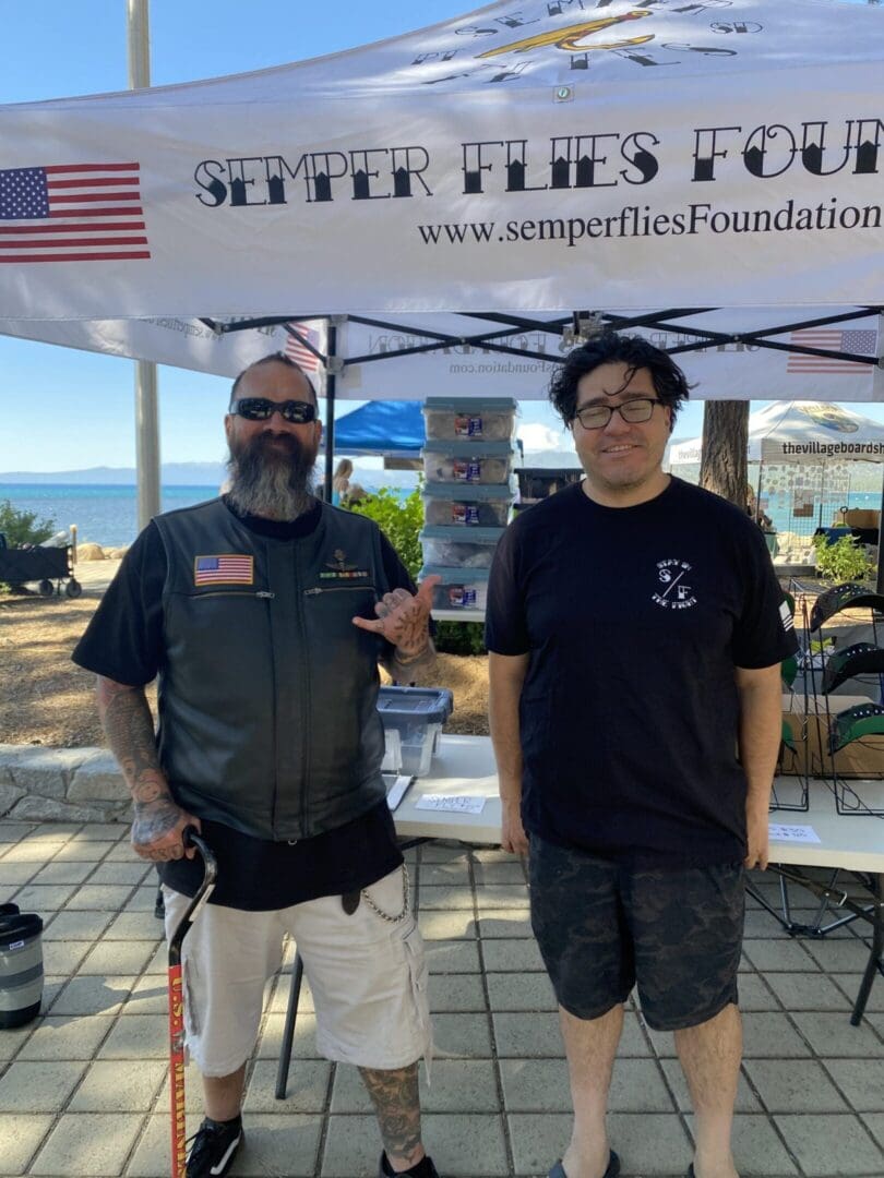 Two men standing at a foundation booth.