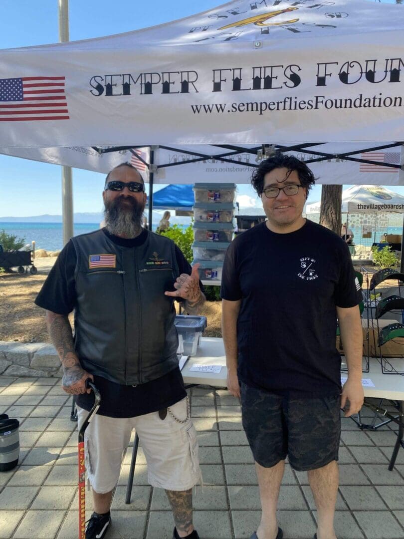 Two men under a Semper Flies tent.