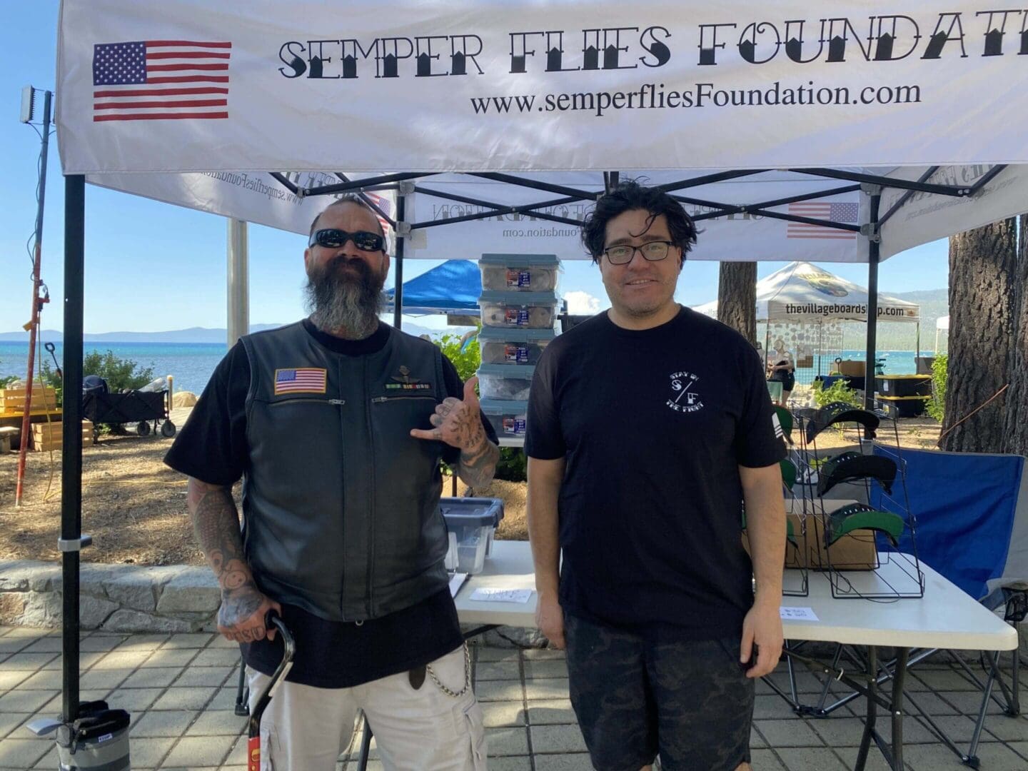 Bearded man with cane and organizer at booth