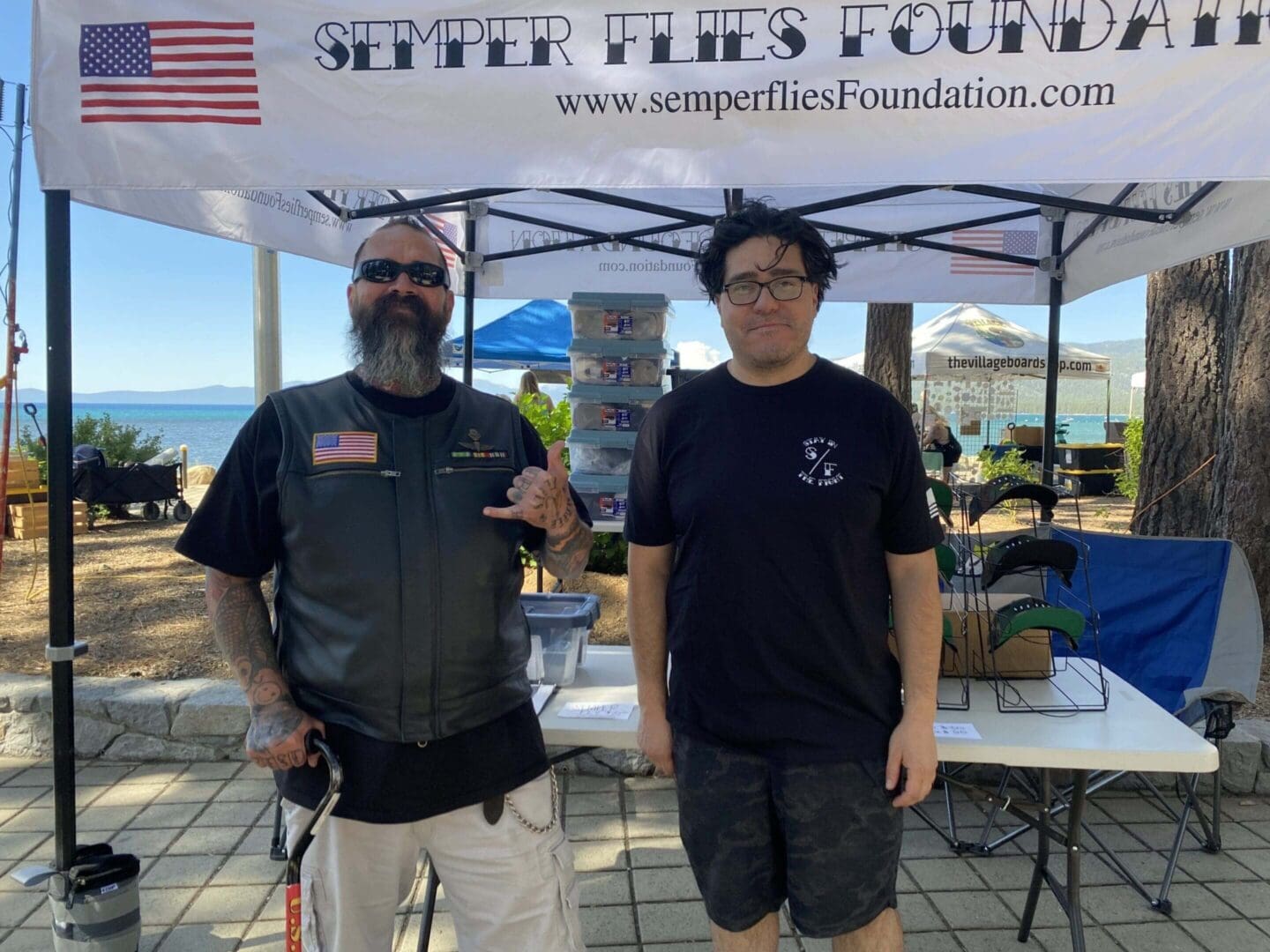 Two men at Semper Flies Foundation booth.
