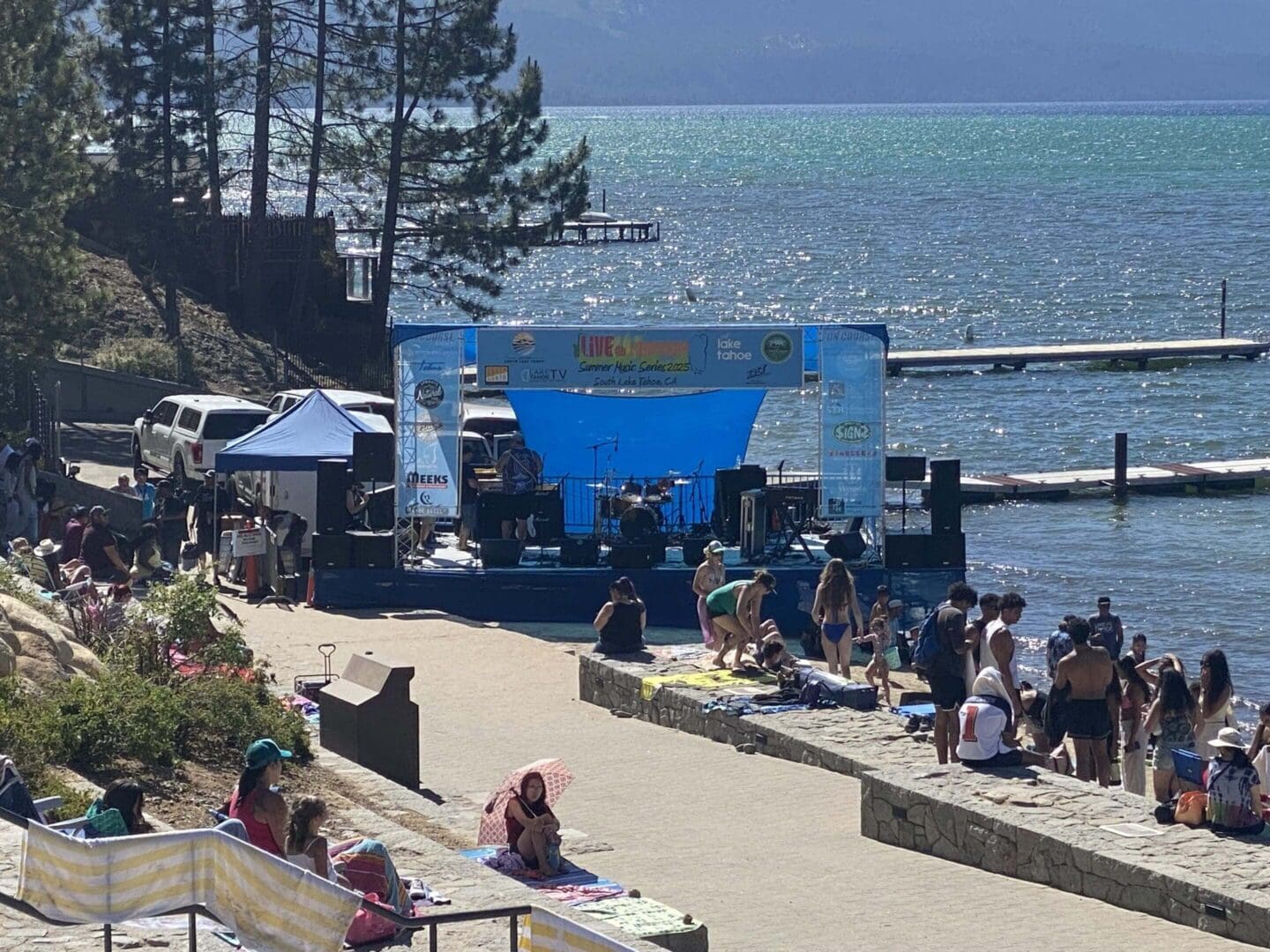 Outdoor concert by the lake with audience.