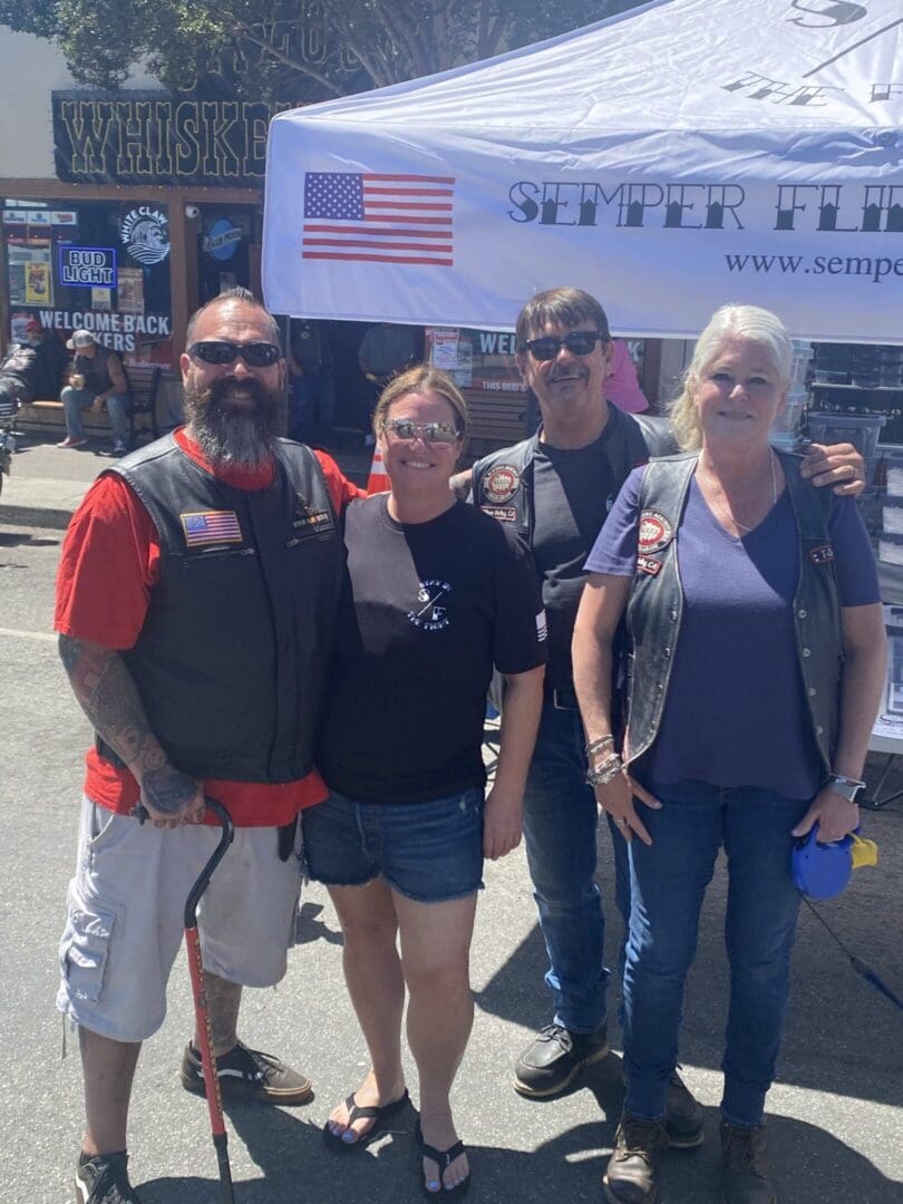 Group posing in front of Semper Fi tent.