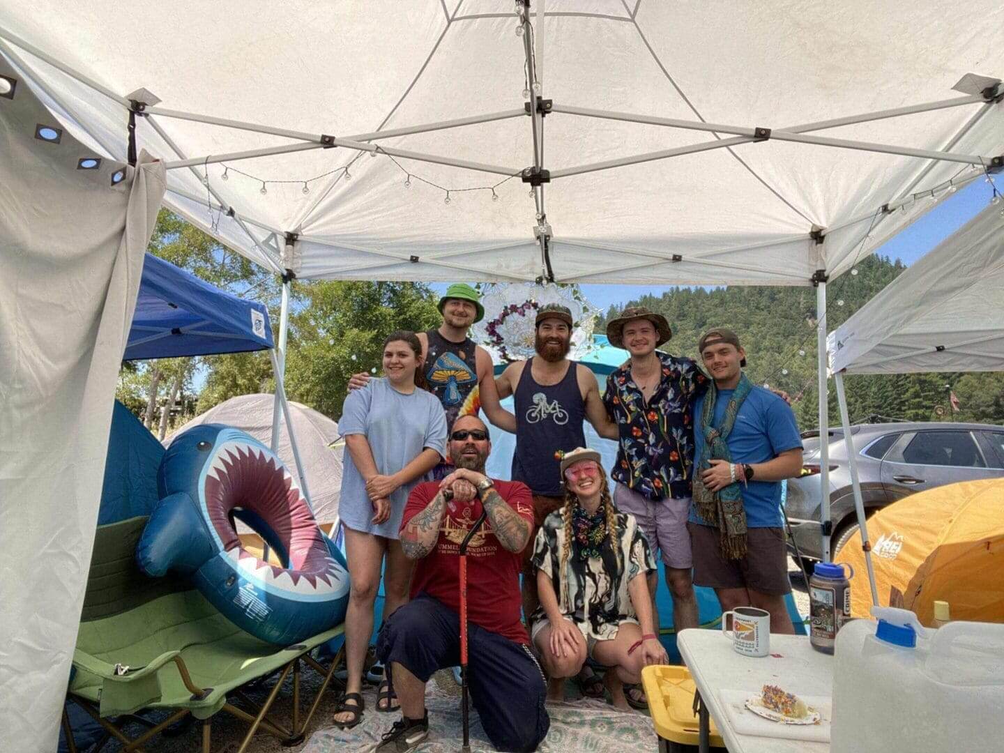 Group of friends under a canopy tent.