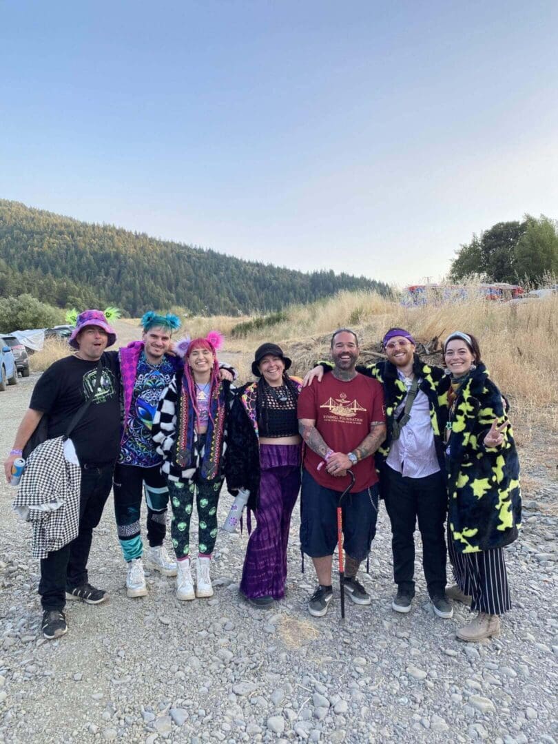 Group of people in colorful outfits outdoors.