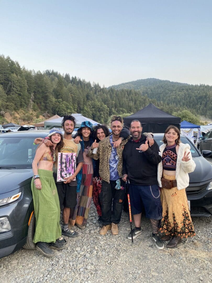 Group of people posing outdoors at event.