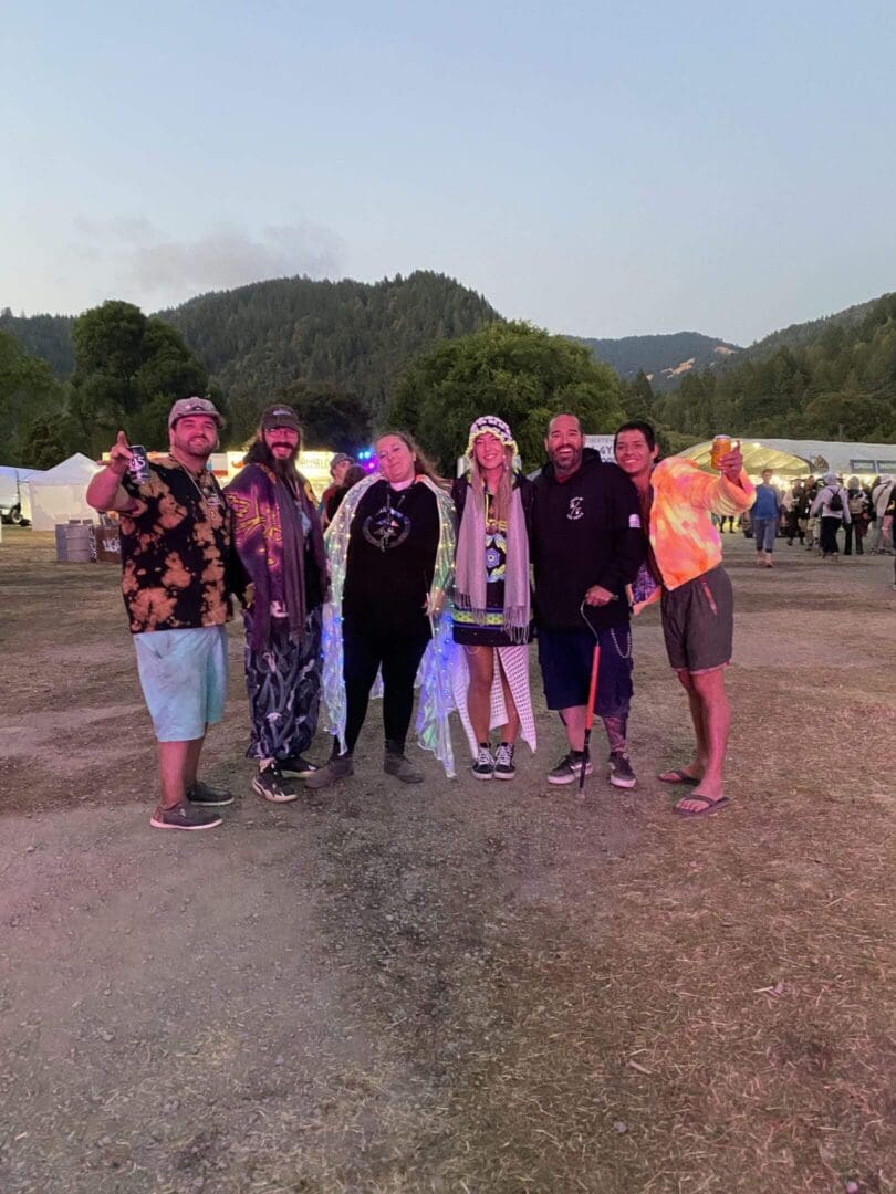 Friends posing with drinks at outdoor fair