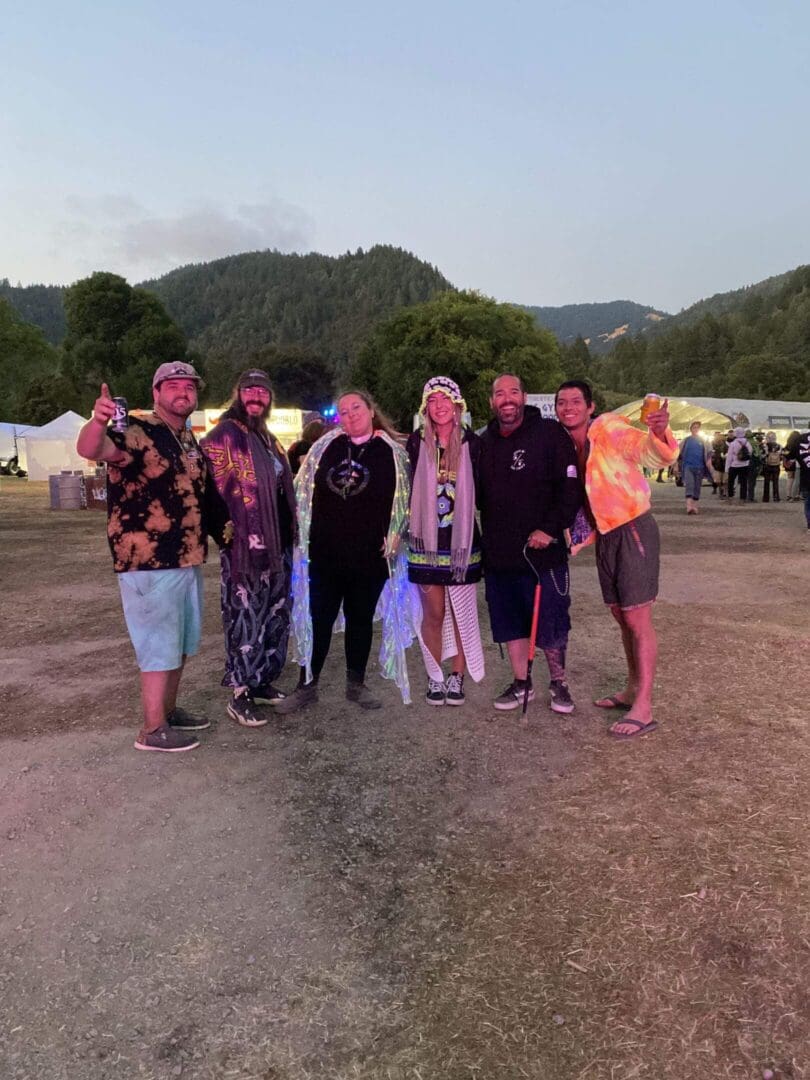 Group wearing glowing cape and festival attire