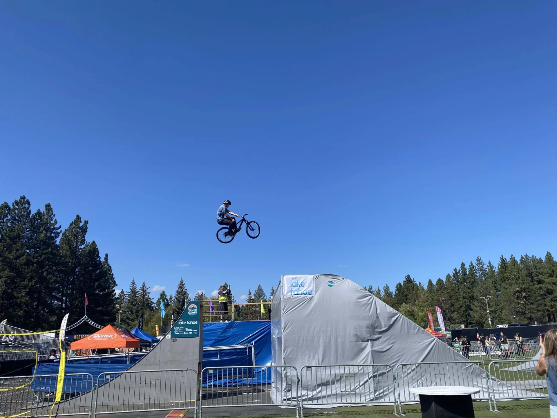 Cyclist airborne over ramp at festival